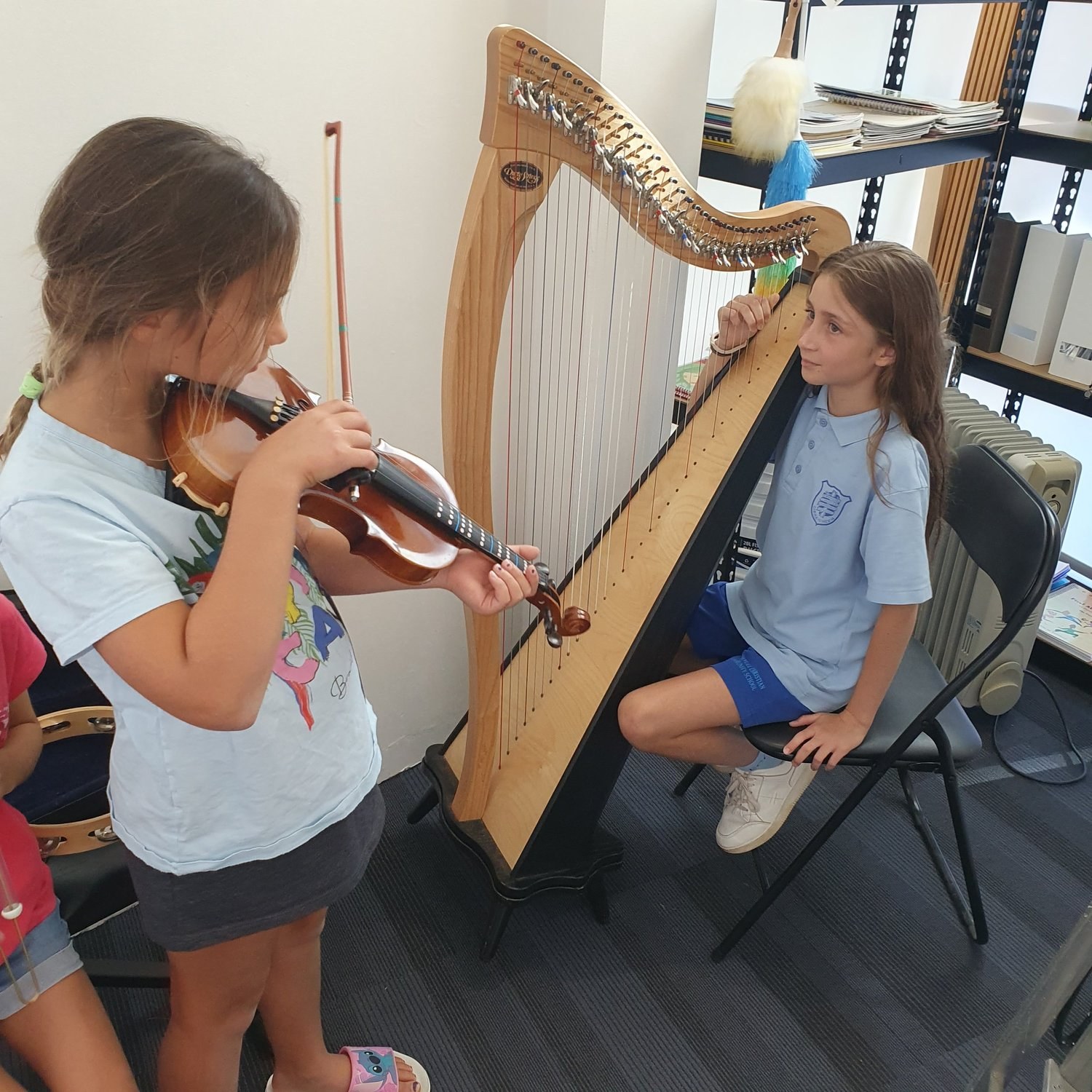 Violin and harp students in a lesson at Music Makers Academy
