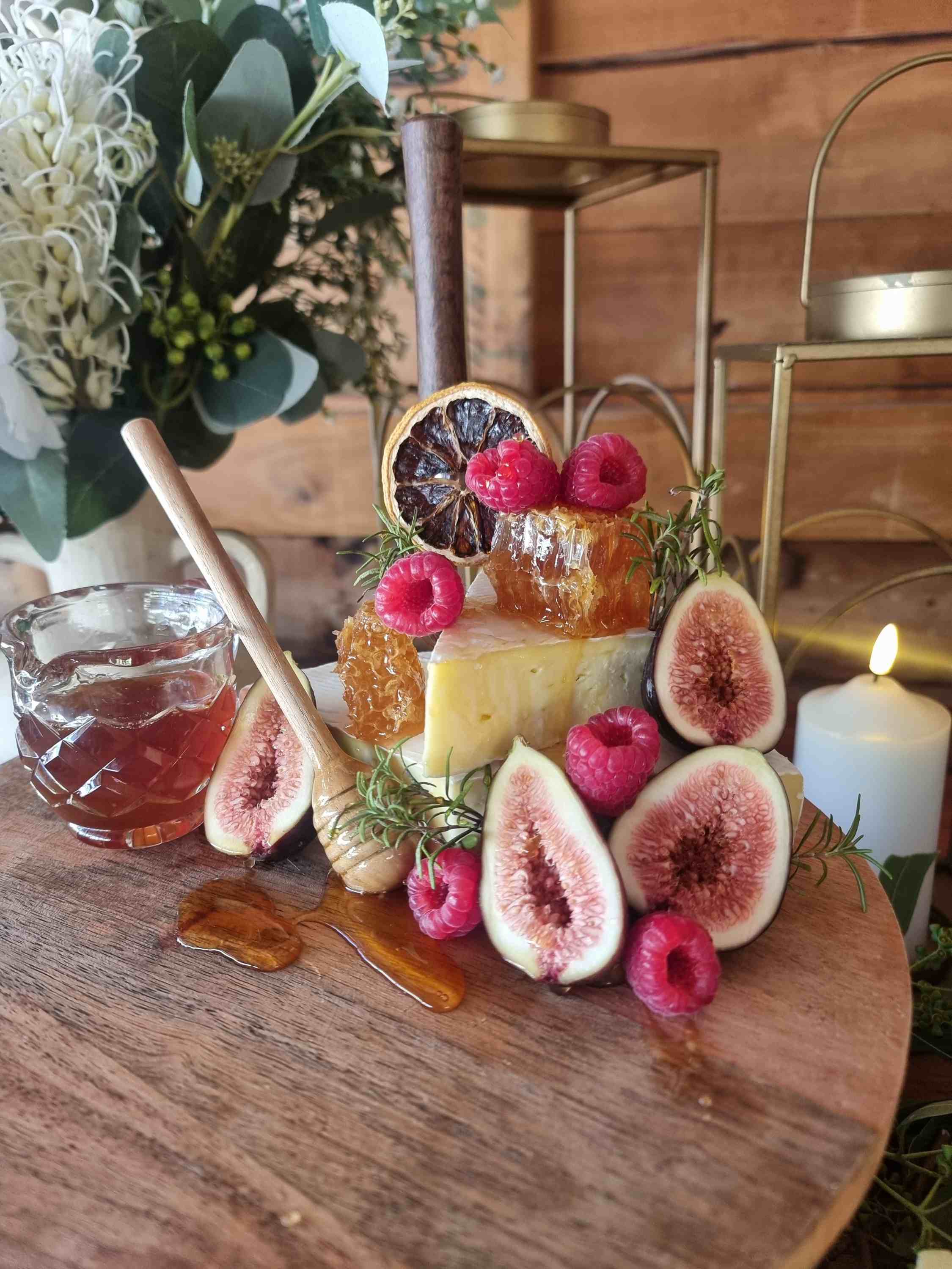 Brie, honeycomb, figs and raspberries styled on a grazing board