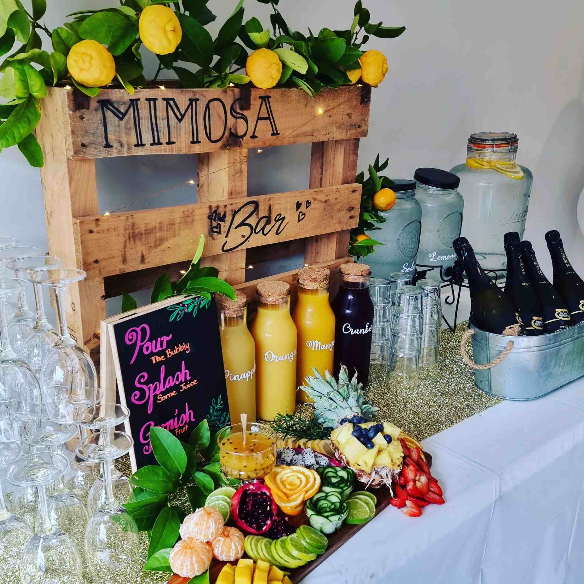 Mimosa bar with juices, bubbly and fresh fruit garnishes
