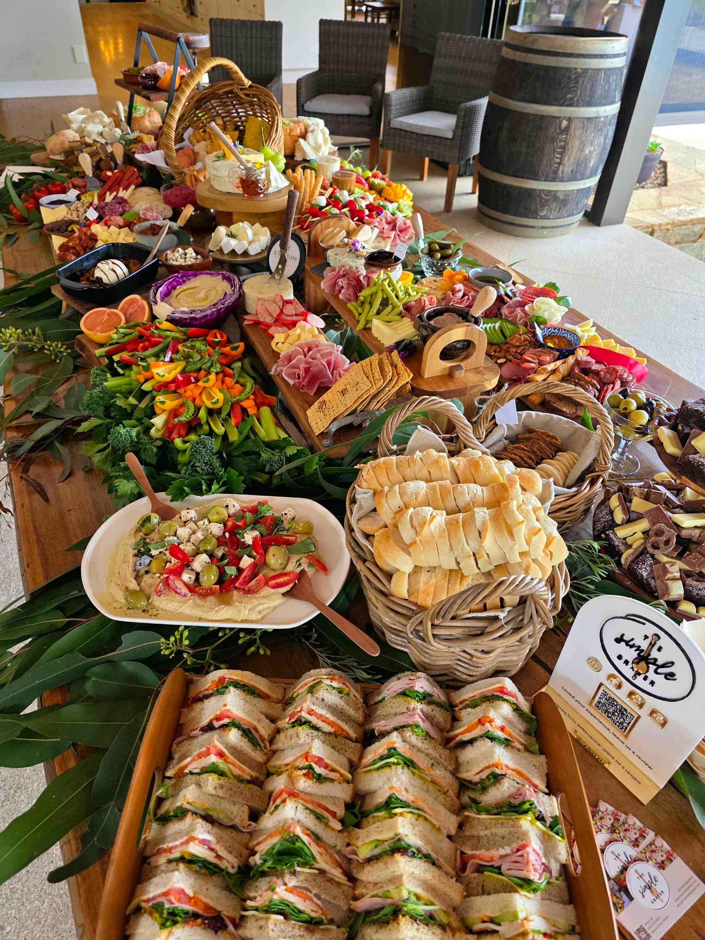 Rustic grazing table with sandwiches, breads and platters